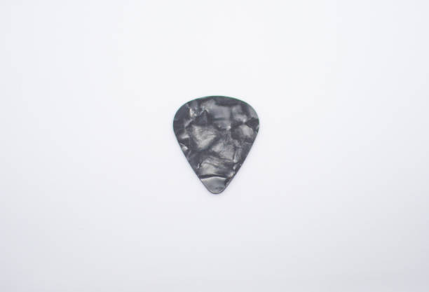 istock black colored guitar pick and an abstract design 2016652688