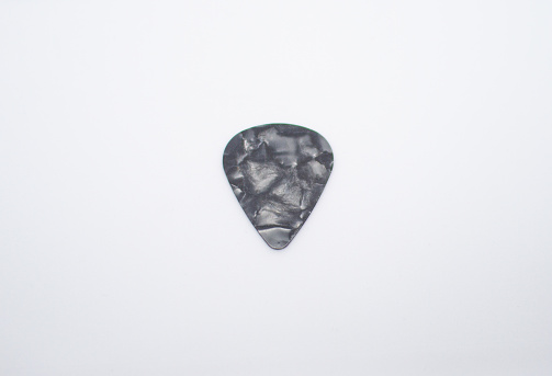 guitar pick with bold color and abstract design