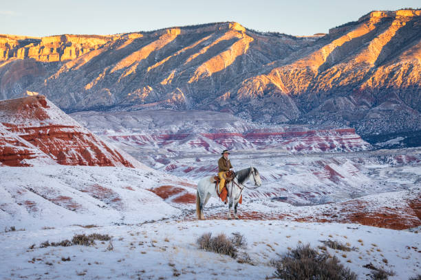 Horseback riding on a Wyoming horse ranch in the winter on a rural landscape.
