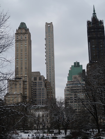 Central Park skating rink and skyline in New York City during Winter.