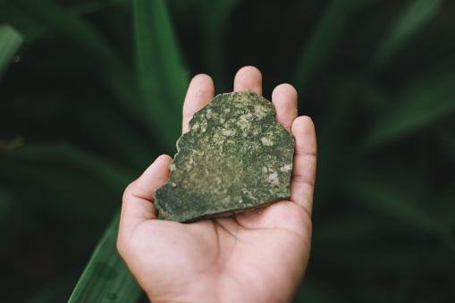 green rock in hand