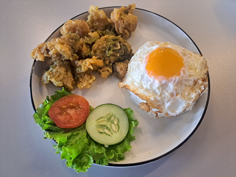 Nasi Ayam Cabe Ijo Or Chili Green Fried Chicken With Rice, Chicken Meat, Sunny Side Up Omelette Egg, Lettuce, Tomato Sliced And Cucumber Sliced. Food Menu.