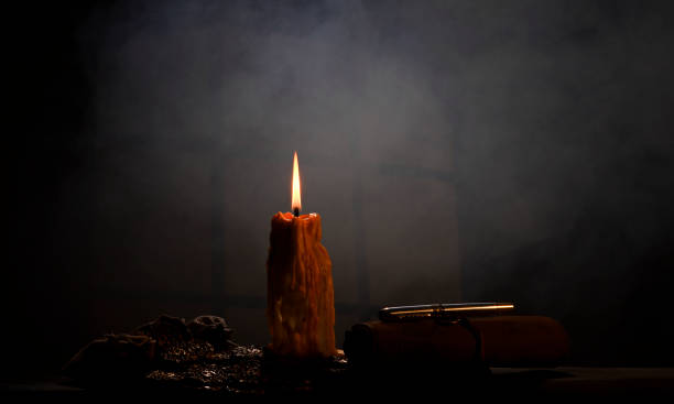 istock Candle with dramatic smoke background and lighting effects and antique colours 2016788732