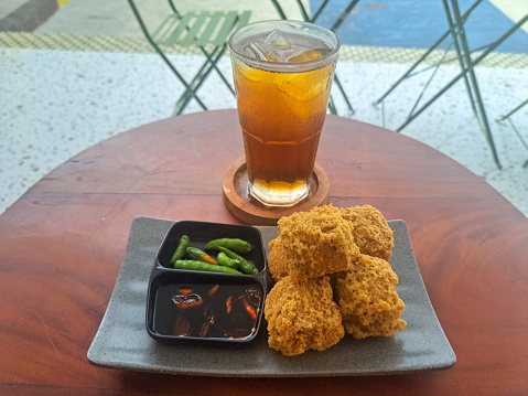 Delicious Tahu Goreng Krispi Or Fried Tofu Crispy And Tea Iced (Es Teh).  Snack And Drink Menu.