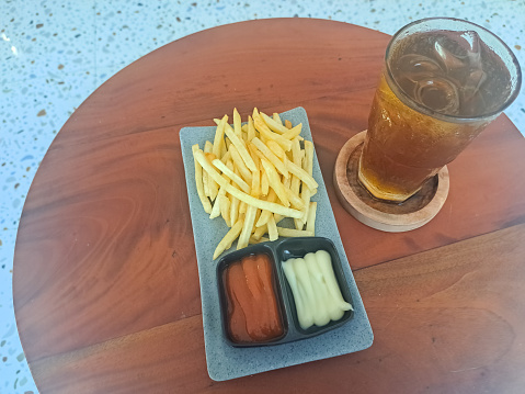 French Fries On Plate With Spicy Sauce,  Mayo Dip And Fresh Tea Iced. Kentang Goreng Dan Es Teh Segar. Snack And Drink Menu.