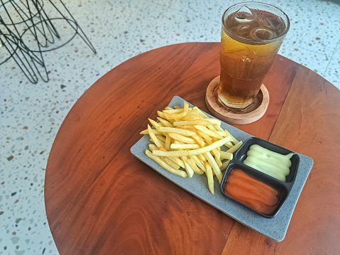 Delicious French Fries On Plate With Spicy Sauce,  Mayo Dip And Fresh Tea Iced. Kentang Goreng Dan Es Teh Segar. Snack And Drink Menu.