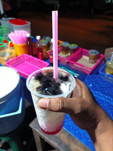 istock coconut ice in a plastic glass with black grass jelly 2016842850