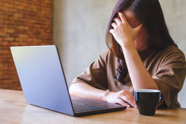 istock A woman get headache and stressed while working online on laptop computer at home 2016846477
