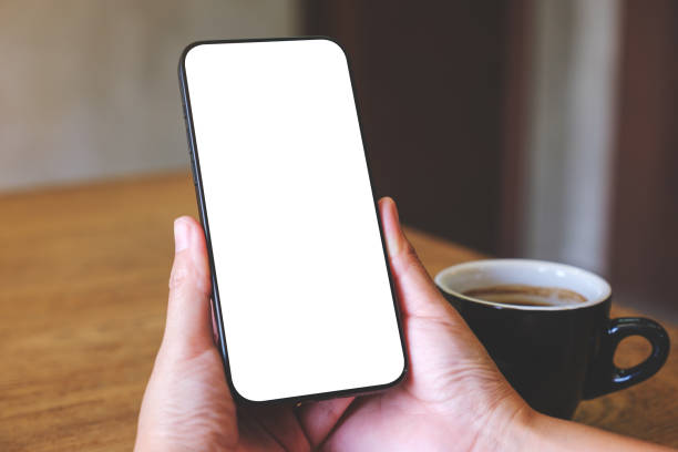 istock Mockup image of a woman holding mobile phone with blank desktop screen 2016847004