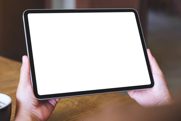 istock Mockup image of a woman holding digital tablet with blank white desktop screen 2016847009