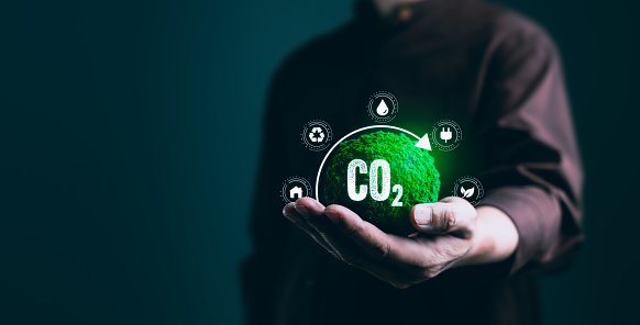 Hand cradles the symbolic concept of CO2 reduction, vision for a sustainable, eco-friendly, ESG (Environmental, Social, Governance) and Net Zero to green business practices and global responsibility