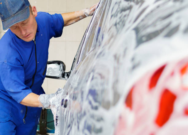 istock a man washing the side of a car 2016888512