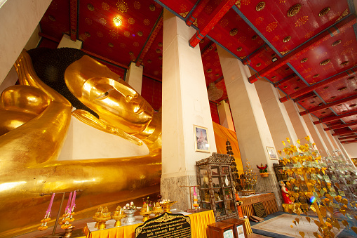 The large golden reclining Buddha has a very beautiful Sukhothai Buddhist style. It is 47 meters and 42 centimeters long and is the third largest in Thailand.Located at Wat Phra Non Chakkasi Worawihan temple , Sing Buri Province in Thailand.