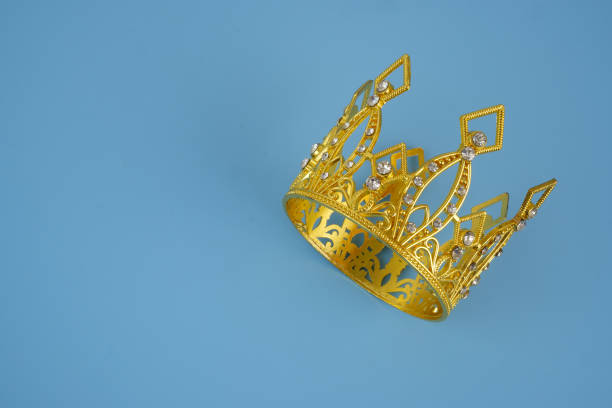 3d royal golden crown with blue diamonds on isolated background. Textured king gold crown. 3d rendering illustration.