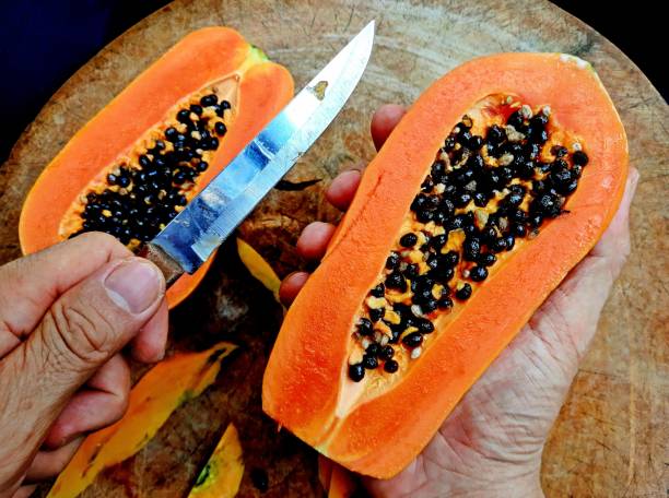 istock Peeling and Cutting Papaya Fruit on cutting board. 2016977073