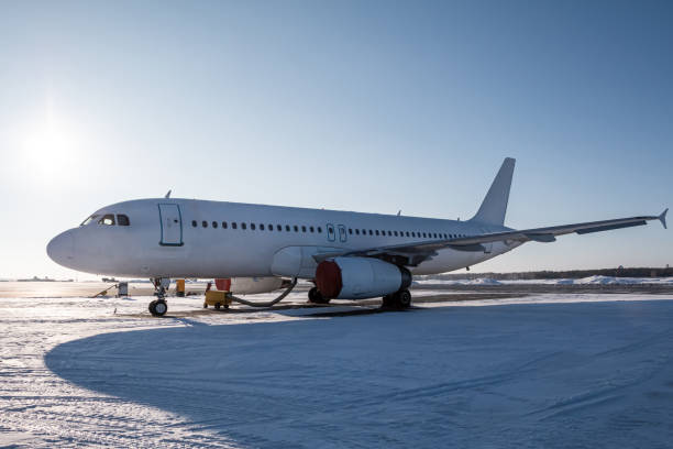 istock White passenger jetliner on the airport apron at winter 2016977074