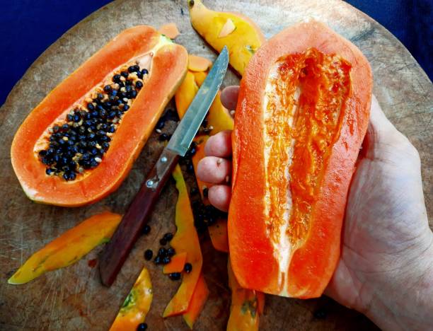 istock Peeling and Cutting Papaya Fruit on cutting board. 2016978622