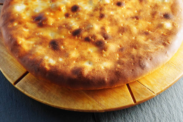 istock Golden Crisped pie on Wooden Board, close up, macro 2016989334
