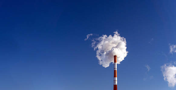 Factory chimneys emit water vapor. Concept air pollution, environmental problems, air emissions. Banner copy space