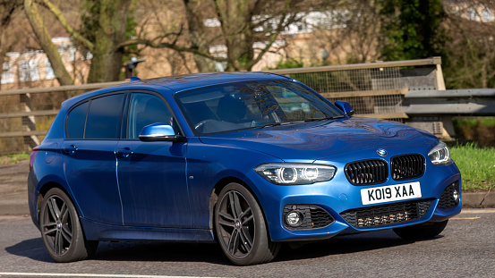 Milton Keynes,UK-Feb 16th 2024: 2019 blue BMW 1 series 118i M sport  car  driving on an English road
