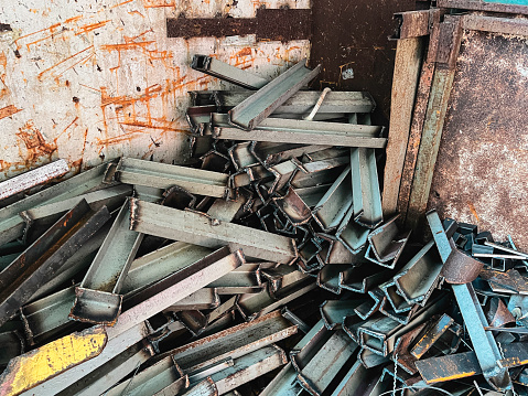 Old and rust steel waste,used metal, piled together in rubbish room,prepare for recycle.
