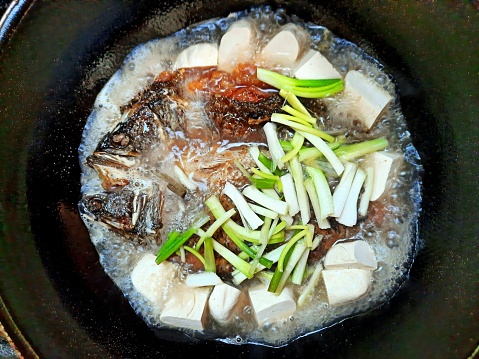 Deep Fried Sea Bass Fish and Tofu in Brown Sauce - food preparation.
