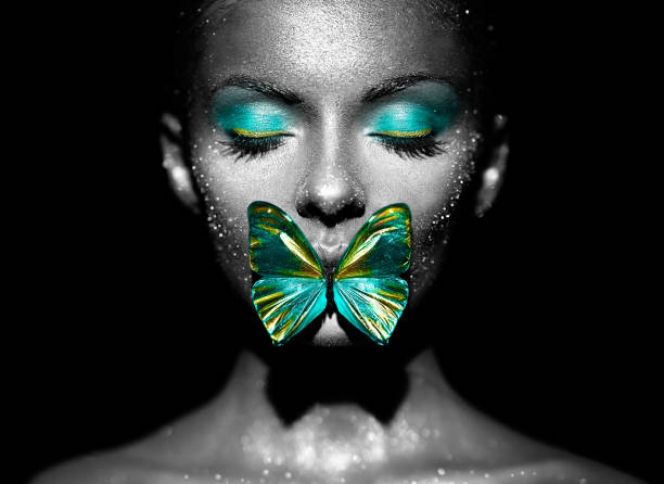 istock Beauty model woman with green butterfly 2017142598