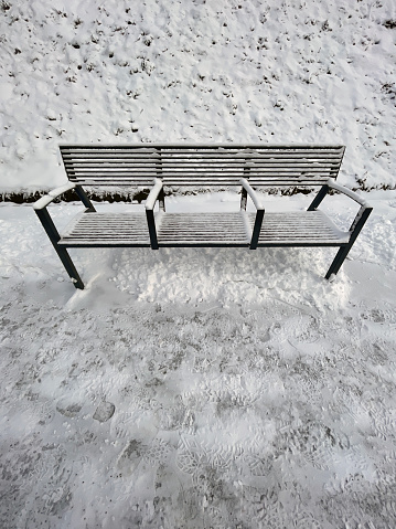Full metal bench covered in snow.