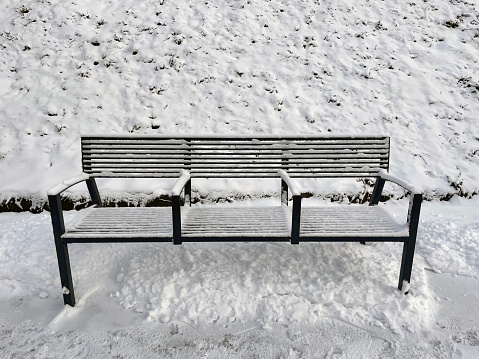 Full metal bench covered in snow.