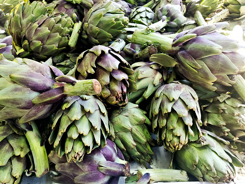 full frame of purple italian artichokes at the farmer's market