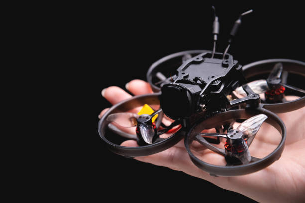 Hands holding a racing drone with a camera. Woman holding a radio-controlled mini drone
