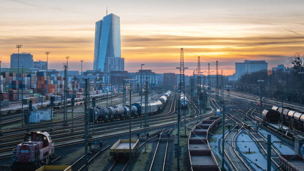 Frankfurt am Main, Germany – January 28, 2024: An open-air train yard with trains on tracks and distant buildings in Frankfurt, Germany.