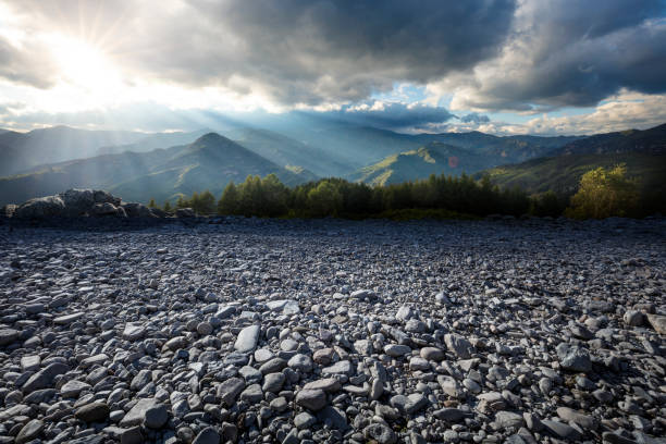 Under dramatic skies, rocky roads and natural mountains