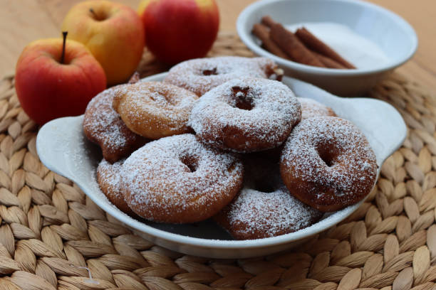 istock Deep fried apple rings with batter sprinkled with powdered sugar  on  table with fresh apples 2017251121