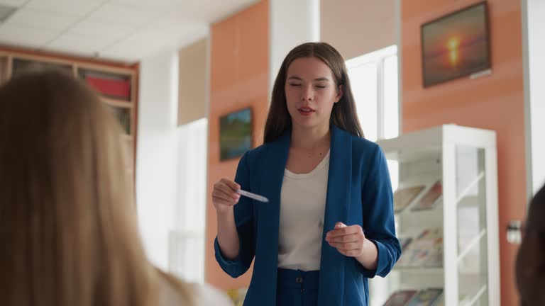 Woman conducts lesson in public library