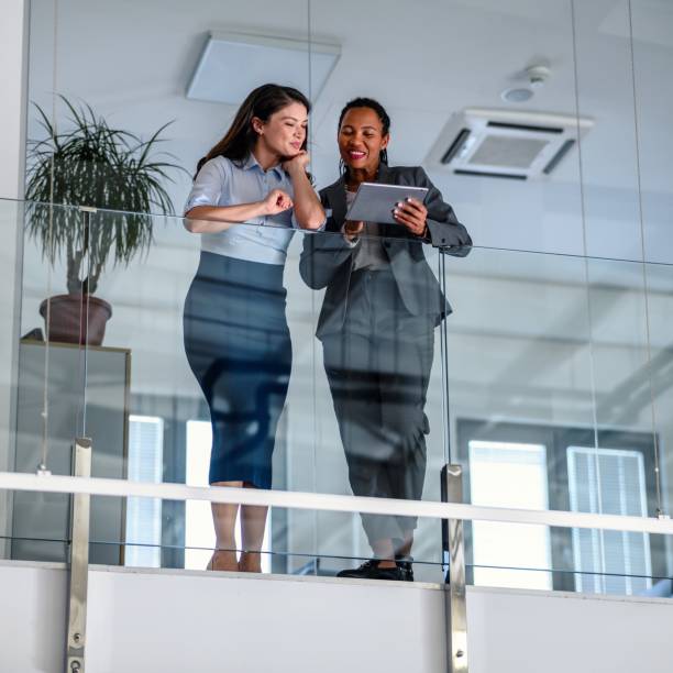 istock Business people leaning against a glass fence and using a digital tablet 2017293302