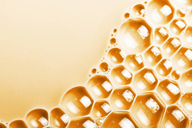 Yellow foam. Suds background. Carmel coffee milk surface.