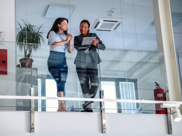 istock Business people leaning against a glass fence and using a digital tablet 2017304241