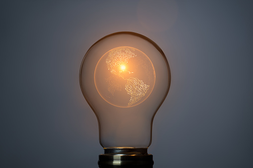 Artificial intelligence earth concept with sphere symbol and glowing light bulb. This file is cleaned and retouched.