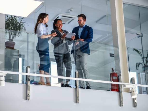 istock Business people leaning against a glass fence and using a digital tablet 2017321777
