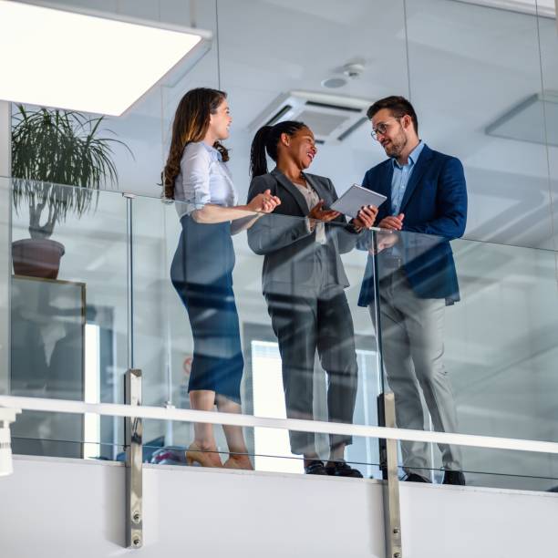 istock Business people leaning against a glass fence and using a digital tablet 2017327967