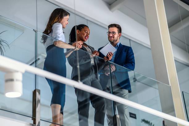 istock Business people leaning against a glass fence and using a digital tablet 2017340566