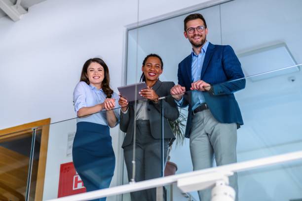 istock Business people leaning against a glass fence and using a digital tablet 2017359268
