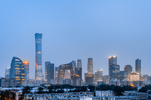 Osaka, Japan - February 28, 2016: The iconic five storey tower of Osaka Castle surrounded by the leafy foliage of Osaka Castle Park and overlooked by the modern skyscrapers of downtown Osaka, Japan's vibrant second city. Panoramic image created from ten contemporaneous sequential photographs. 