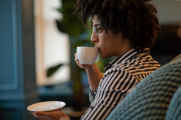 istock Smiling young man in striped shirt having coffee 2017429069