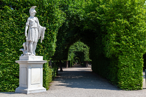 A marble classic soldier statue with a helmet and sword at the gardens of the summer Schönbrunn palace in Vienna, Austria.