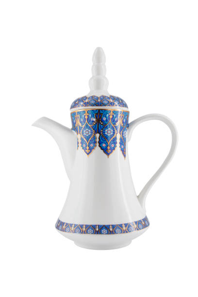 Close up of traditional Turkish coffee being poured from a copper cezve into a white porcelain cup on an ornate tray. Authentic coffee preparation ritual representing culture, tradition, hospitality, caffeine, hot beverage and slow living lifestyle. Ideal for food, drink, cafe, culture and travel concepts.