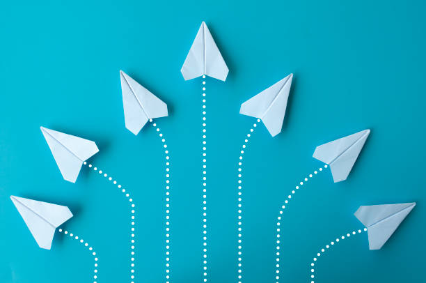 istock Top view of white paper airplanes origami flying at different direction 2017507004