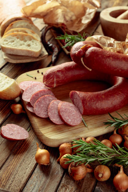 istock Smoked sausage with bread and spices on a old wooden table. 2017580827