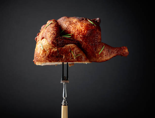 istock Smoked chicken on a fork sprinkled with rosemary. 2017581400